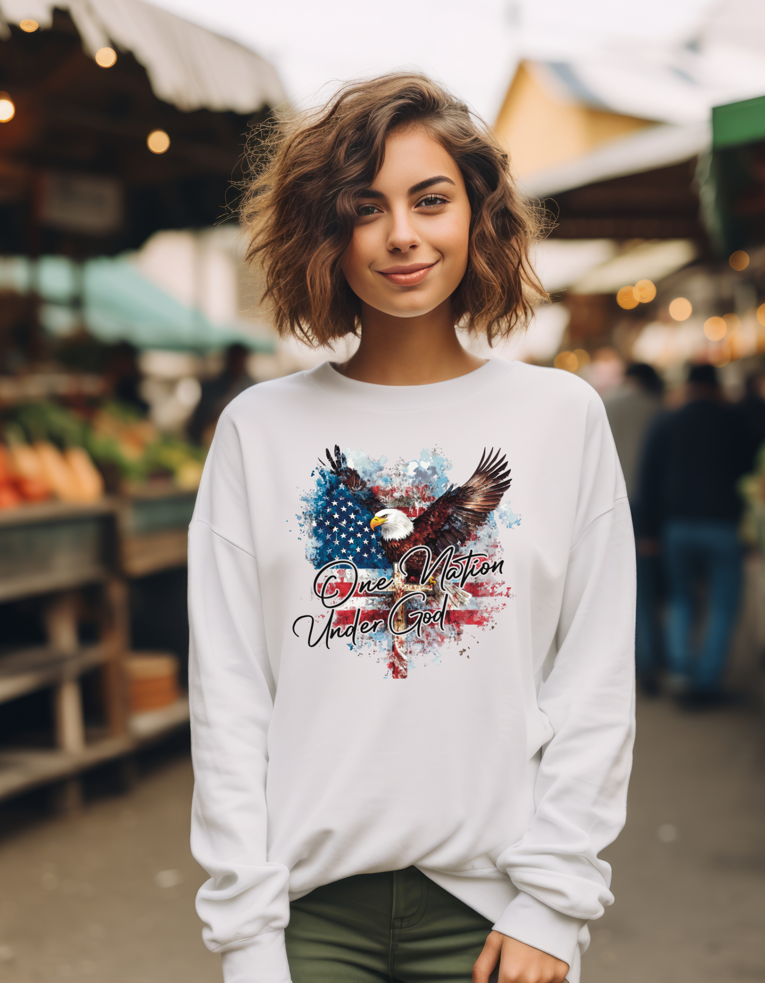 Woman wearing a sweatshirt with an eagle and American flag design in an outdoor setting.