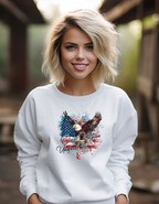 Woman wearing a white sweatshirt with an eagle and American flag design outdoors.