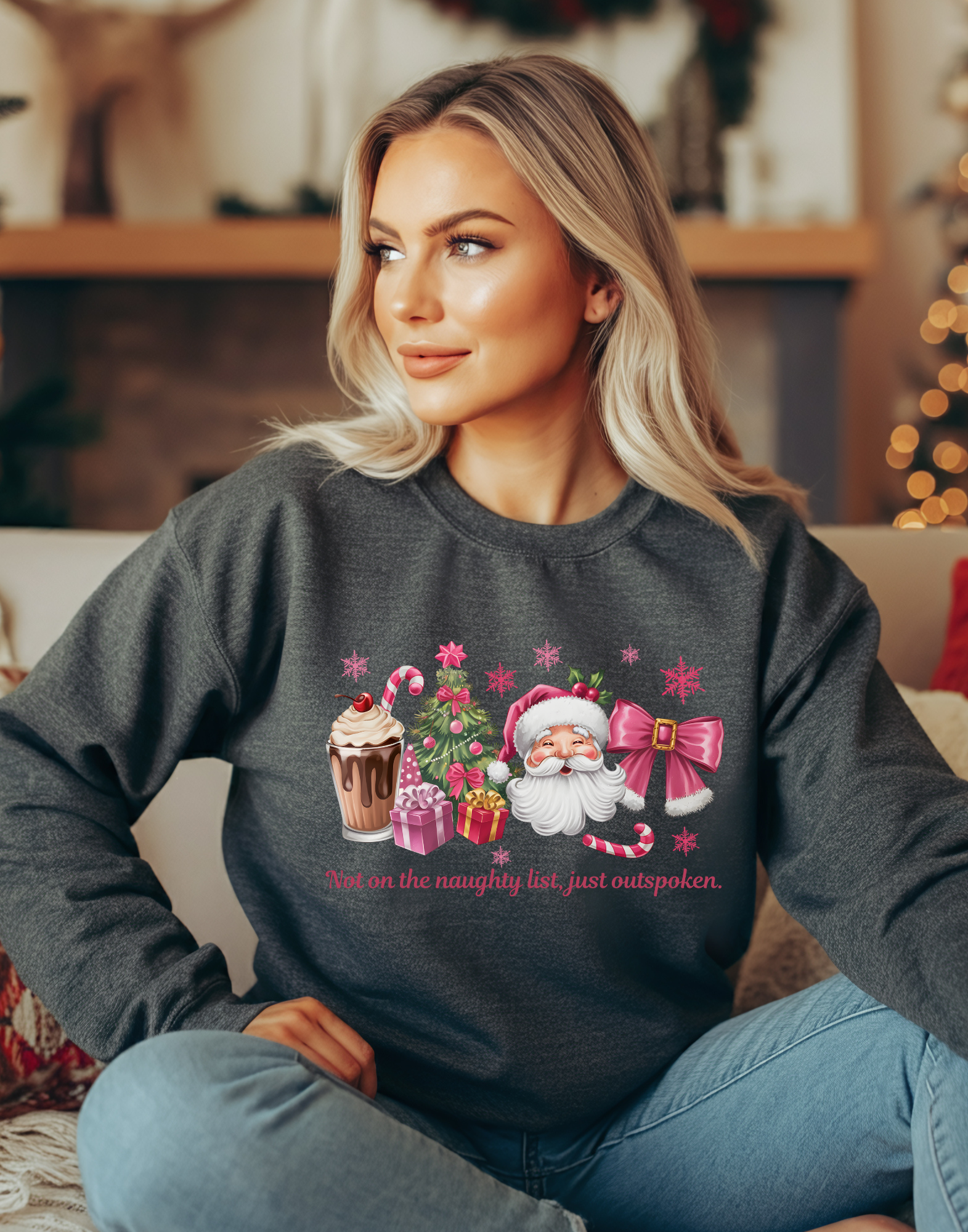 Woman wearing a dark gray Christmas-themed sweatshirt with Santa Claus and festive elements.